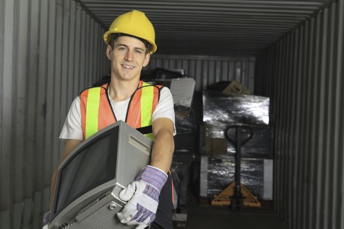 Worker carrying furniture down stairs in a garden flat clearance